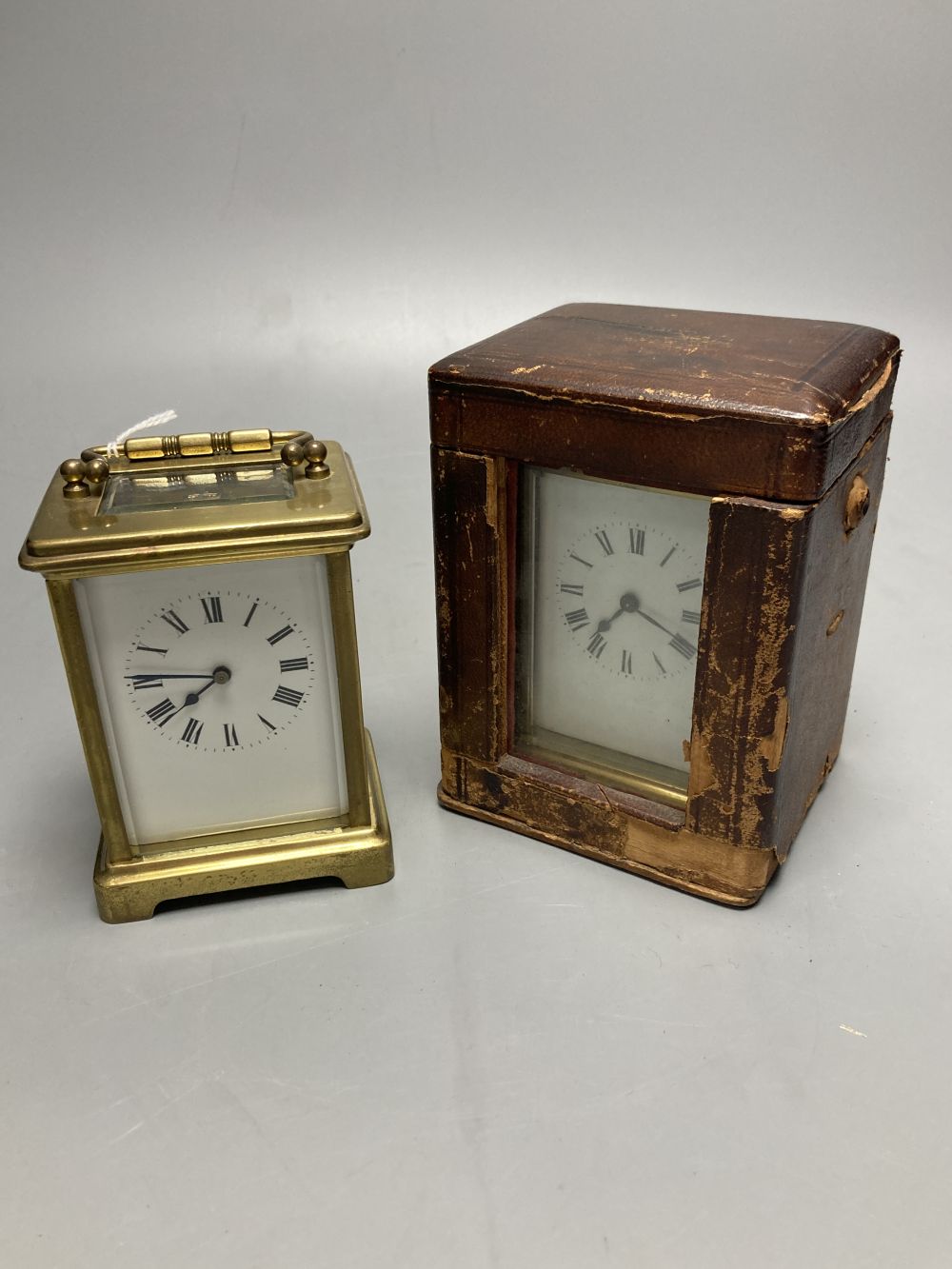 A gilt-brass carriage timepiece, with white enamelled Roman dial and outer travelling case and another carriage clock (2)